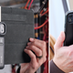 The FLIR One Edge Pro thermal camera shown clamped to an iPad and an iPhone.